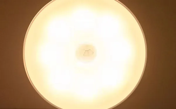 Round sensor light close-up, warm glow